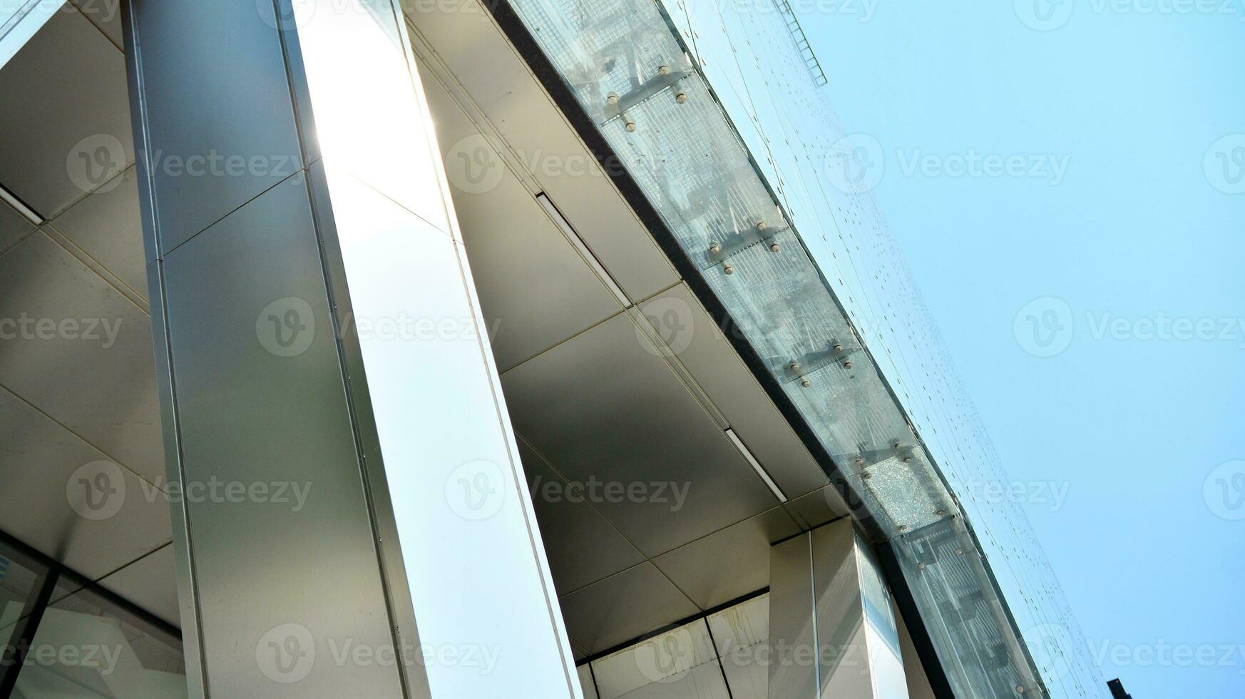 Combination of metal and glass wall material. Steel facade on columns. Abstract modern architecture. High-tech minimalist office building. Contemporary business architecture abstract fragment. photo