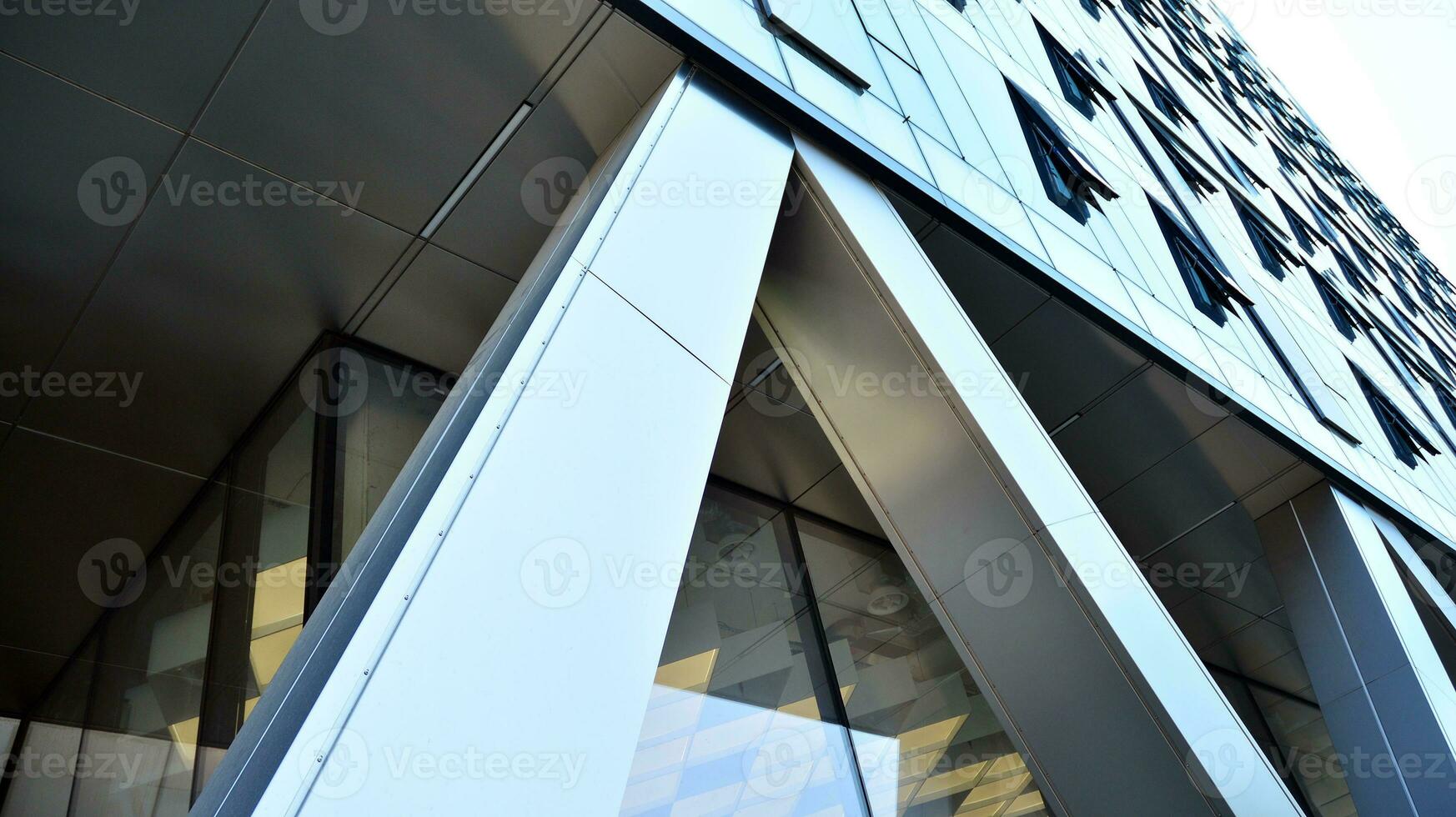 Combination of metal and glass wall material. Steel facade on columns. Abstract modern architecture. High-tech minimalist office building. Contemporary business architecture abstract fragment. photo