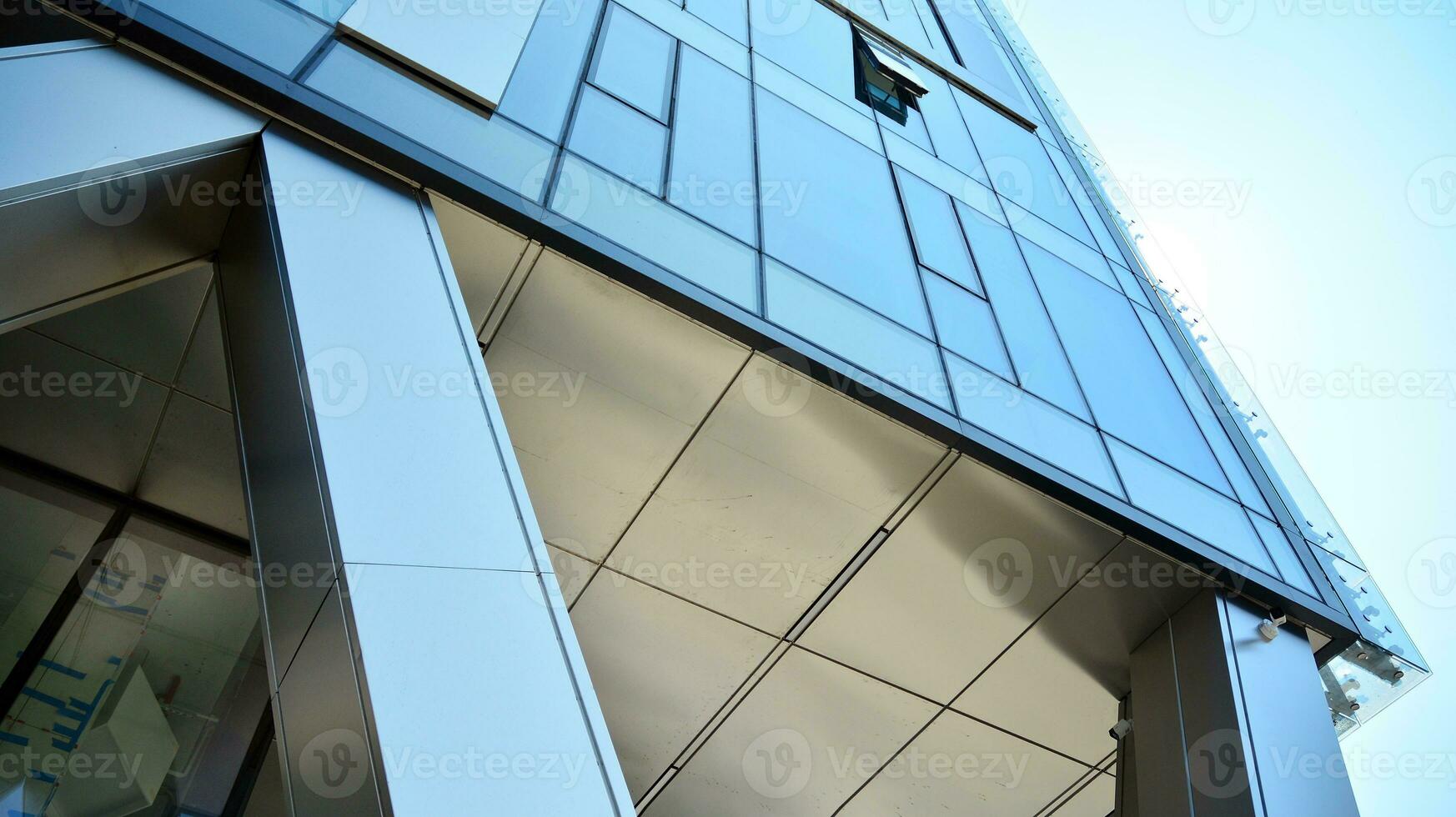 Combination of metal and glass wall material. Steel facade on columns. Abstract modern architecture. High-tech minimalist office building. Contemporary business architecture abstract fragment. photo