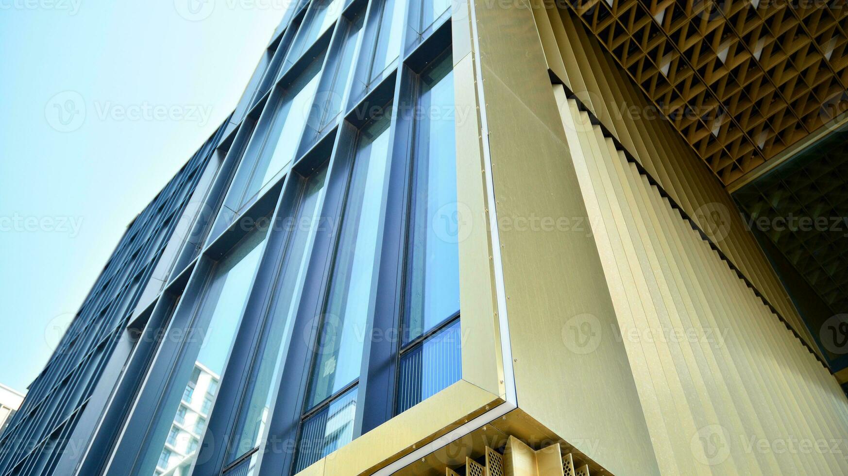 Combination of metal and glass wall material. Steel facade on columns. Abstract modern architecture. High-tech minimalist office building. Contemporary business architecture abstract fragment. photo