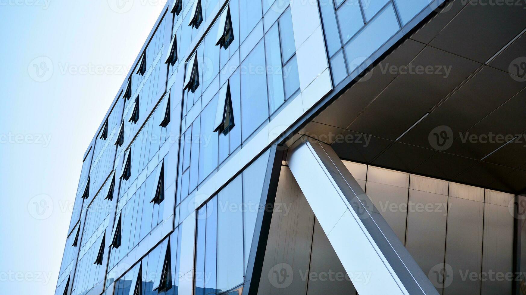 Combination of metal and glass wall material. Steel facade on columns. Abstract modern architecture. High-tech minimalist office building. Contemporary business architecture abstract fragment. photo