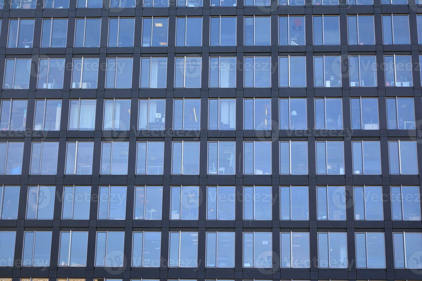 Bottom view of modern skyscrapers in business district against blue sky. Looking up at business buildings in downtown. photo