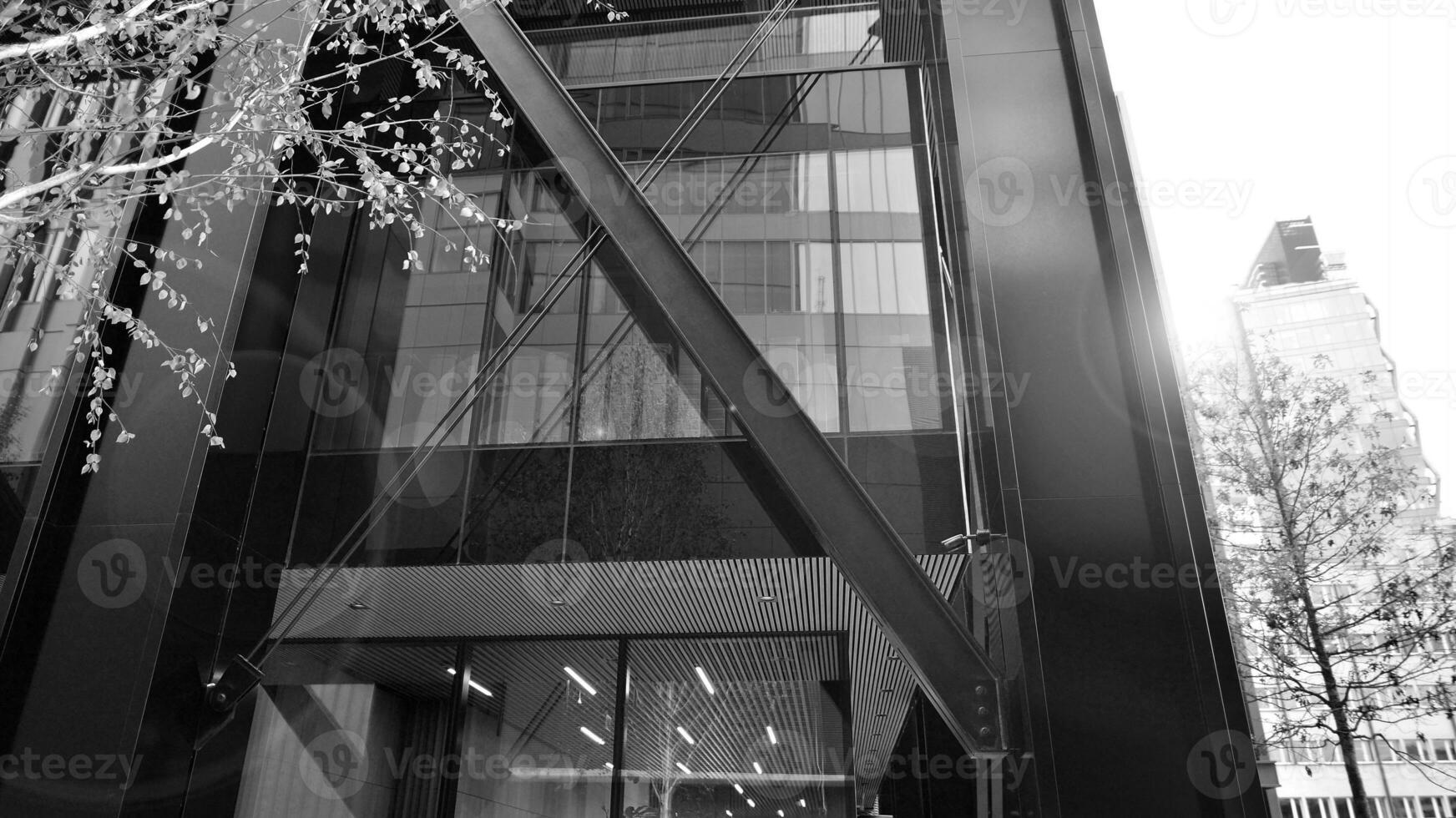 Combination of metal and glass wall material. Steel facade on columns. Abstract modern architecture. High-tech minimalist office building. Black and white. photo