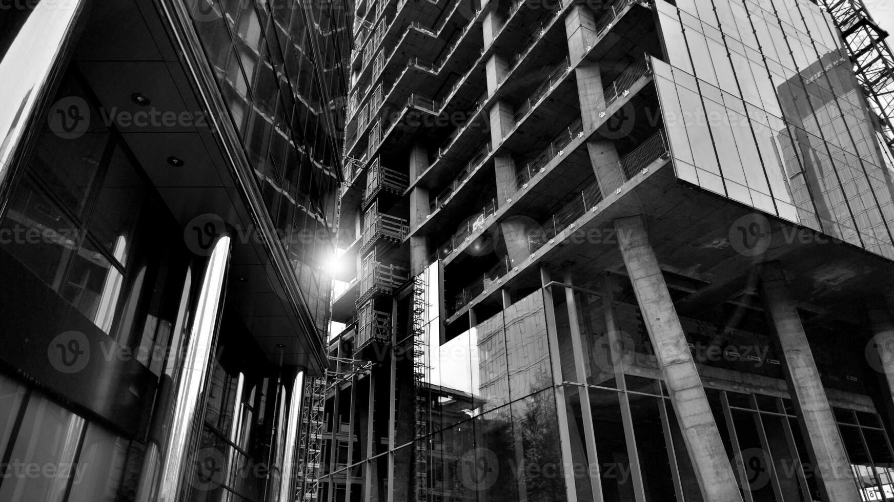 Combination of metal and glass wall material. Steel facade on columns. Abstract modern architecture. High-tech minimalist office building. Black and white. photo