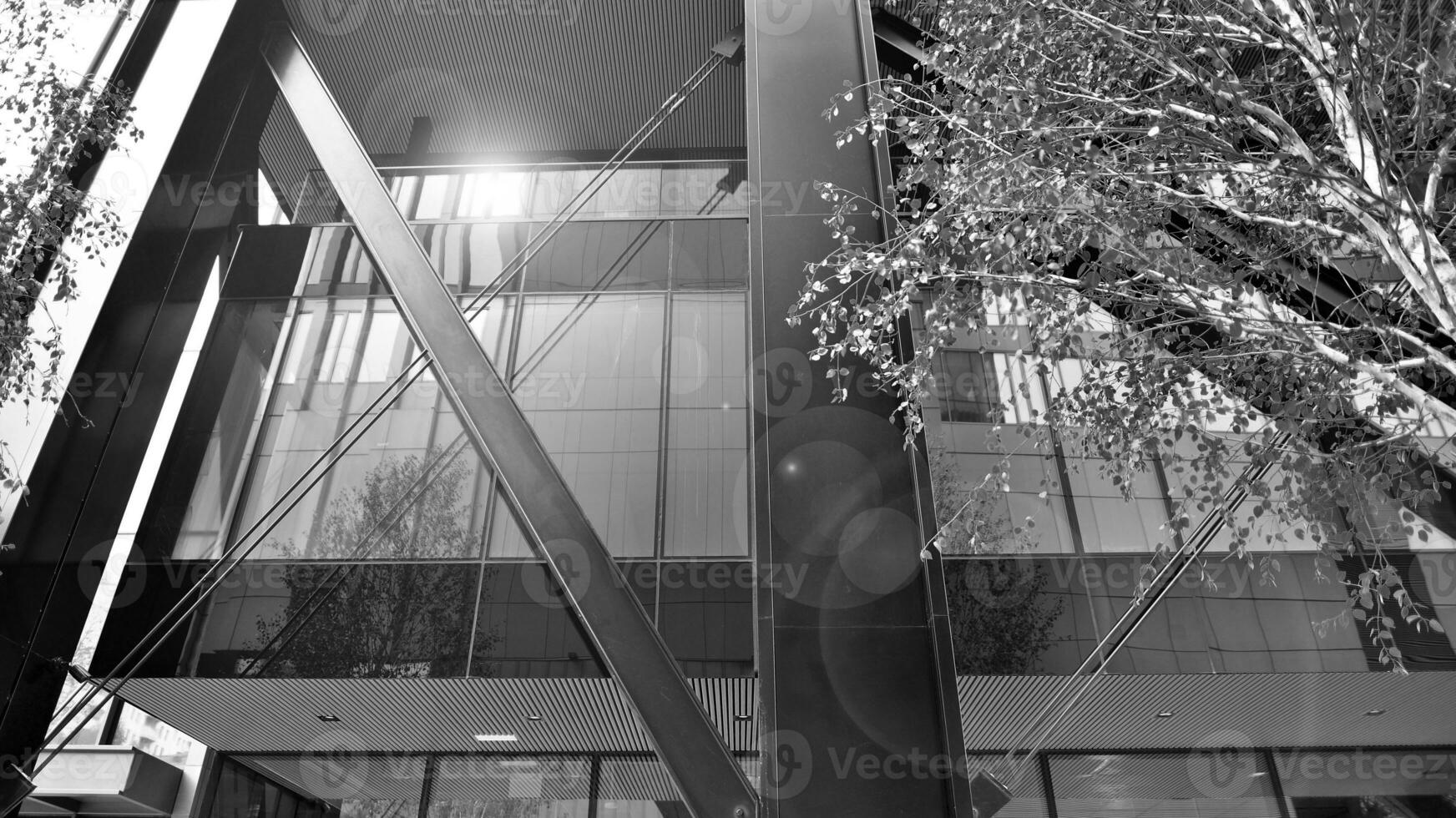 Combination of metal and glass wall material. Steel facade on columns. Abstract modern architecture. High-tech minimalist office building. Black and white. photo