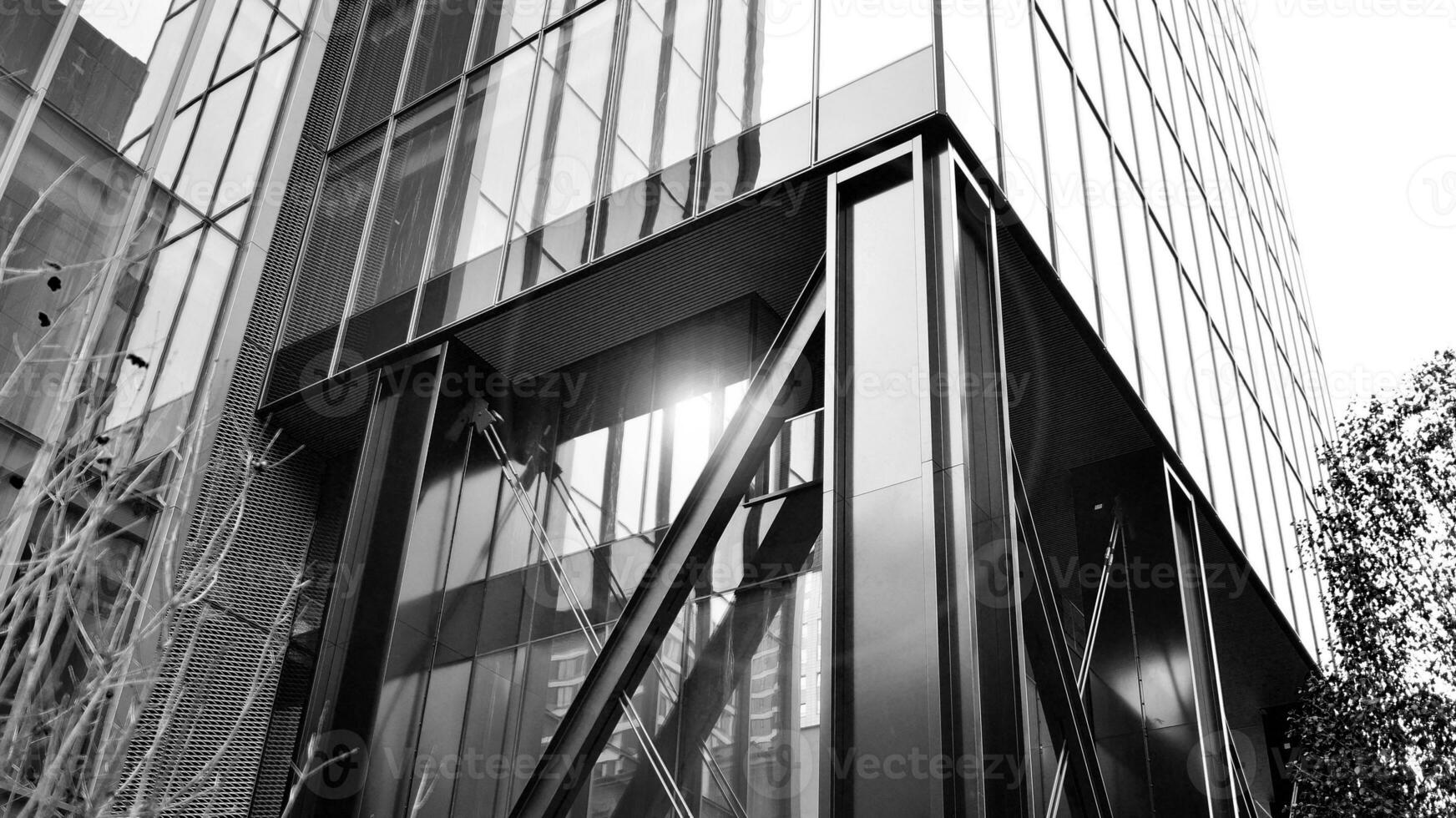 Combination of metal and glass wall material. Steel facade on columns. Abstract modern architecture. High-tech minimalist office building. Black and white. photo