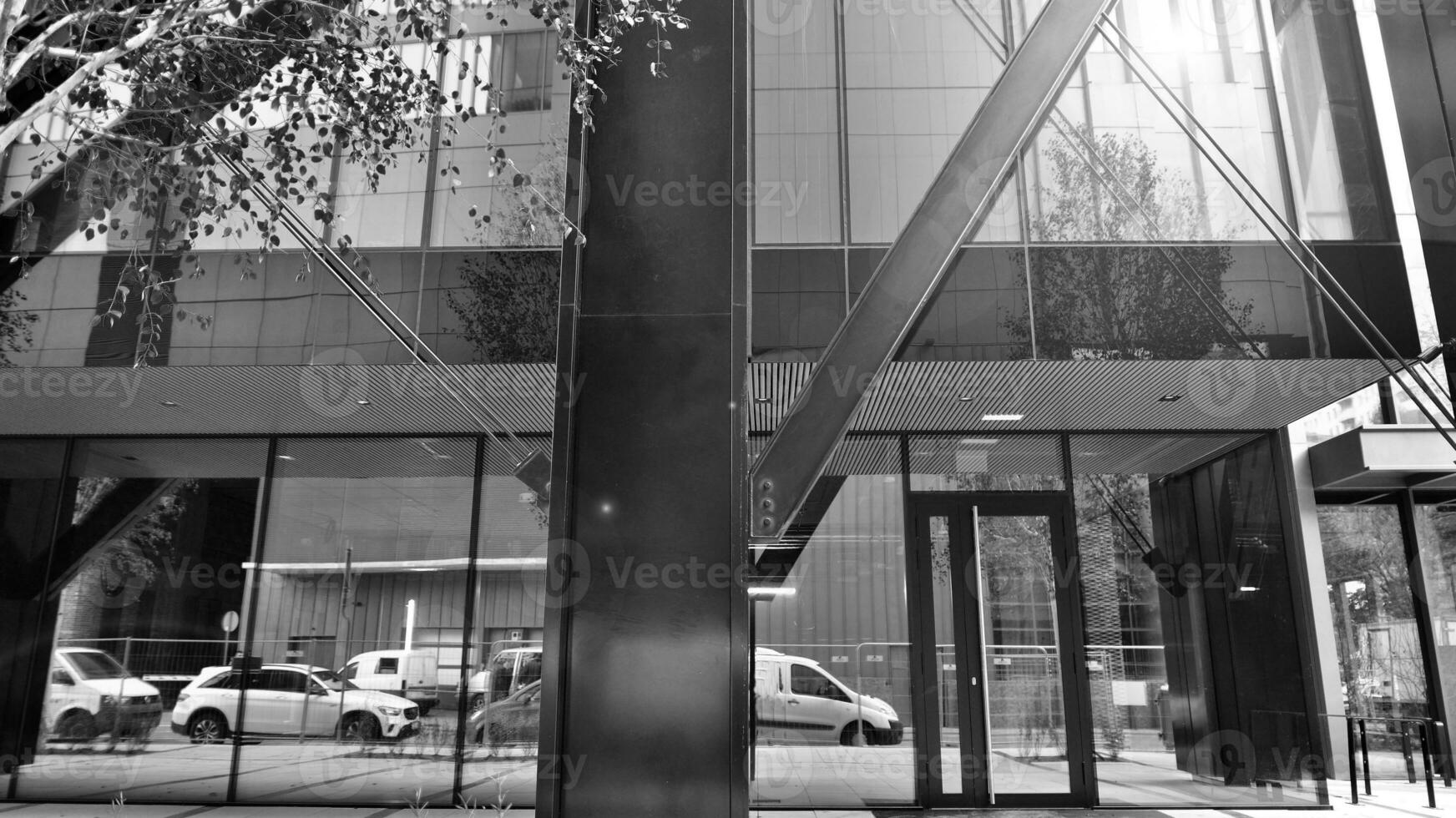 Combination of metal and glass wall material. Steel facade on columns. Abstract modern architecture. High-tech minimalist office building. Black and white. photo