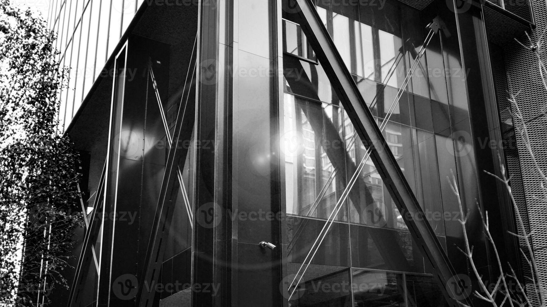 Combination of metal and glass wall material. Steel facade on columns. Abstract modern architecture. High-tech minimalist office building. Black and white. photo