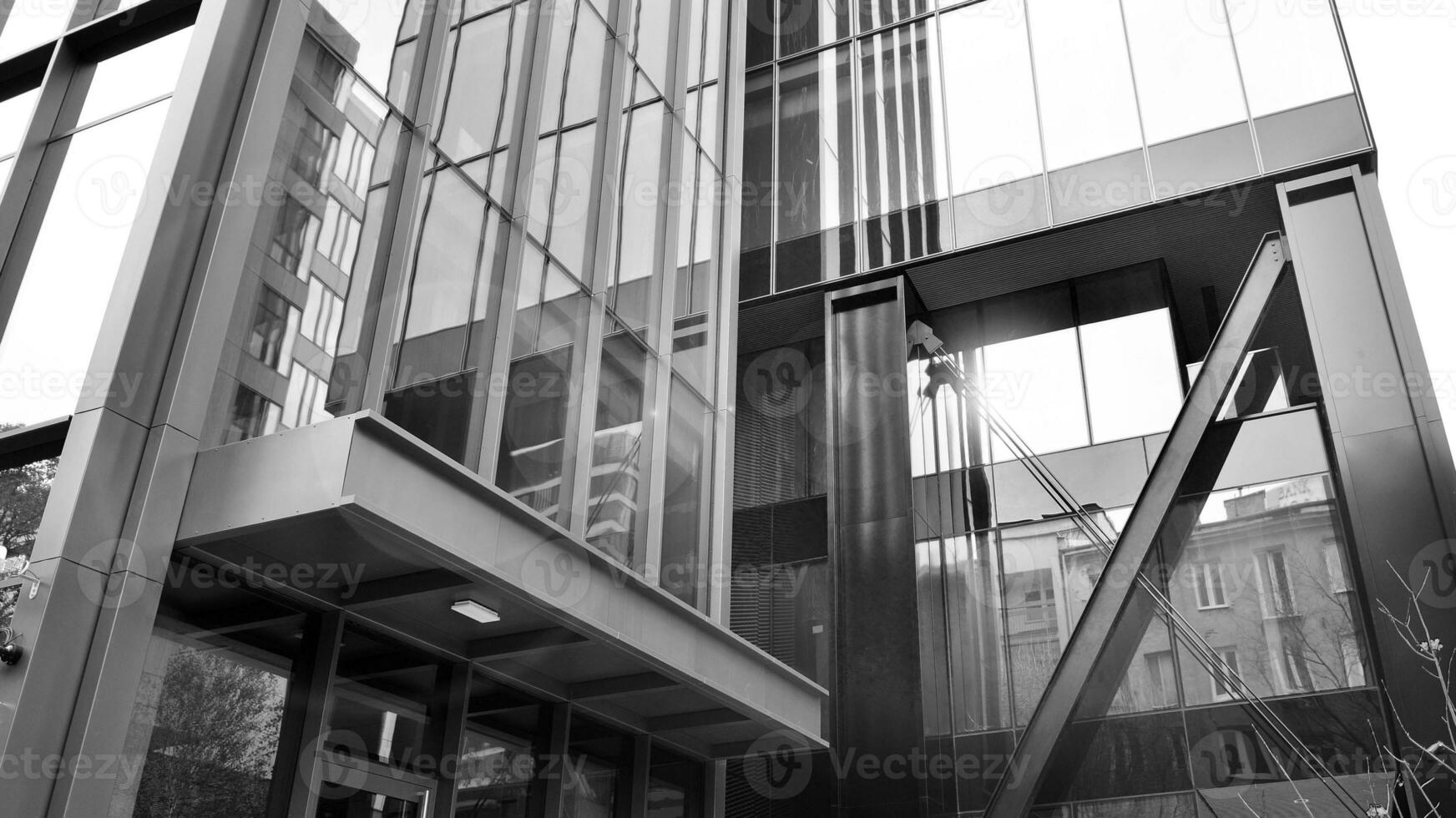 Combination of metal and glass wall material. Steel facade on columns. Abstract modern architecture. High-tech minimalist office building. Black and white. photo