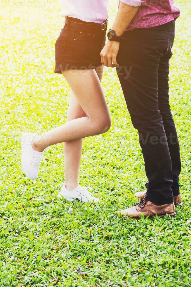 Body part. Couple standing in park. They are kiss and hug.concept for love. photo