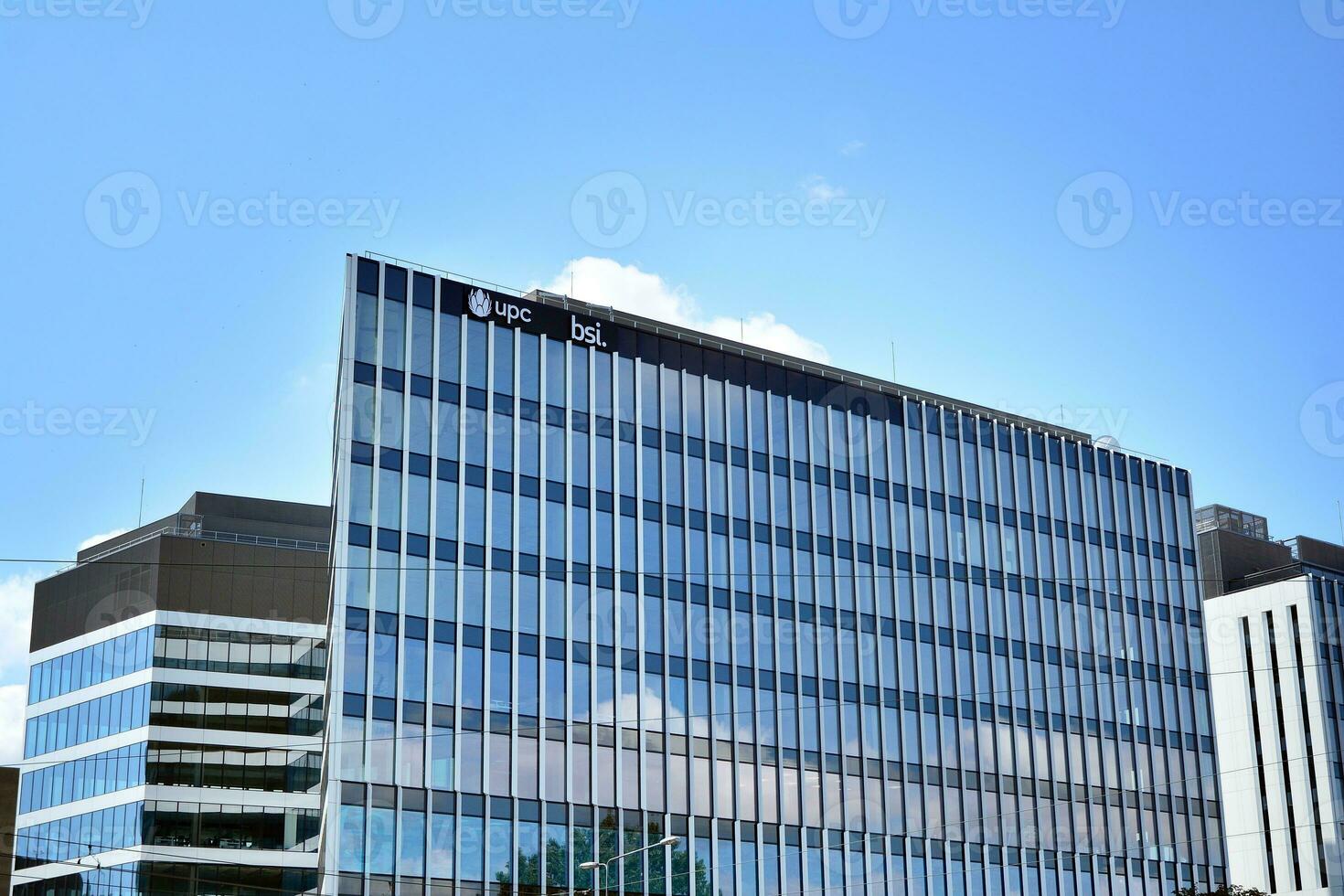 Modern office building in the city with windows and  steel and aluminum panels wall. Contemporary commercial architecture, vertical converging geometric lines. photo