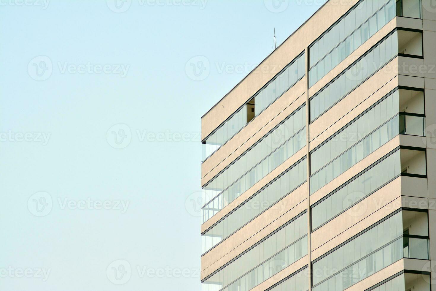 Residential Building on sky background. Facade of a modern housing construction with of balconies. photo