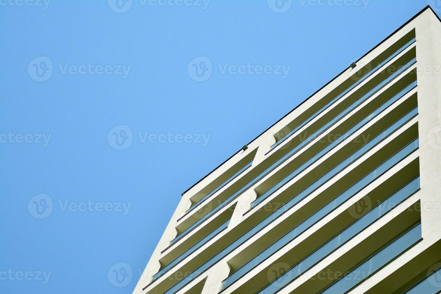 Residential Building on sky background. Facade of a modern housing construction with of balconies. photo