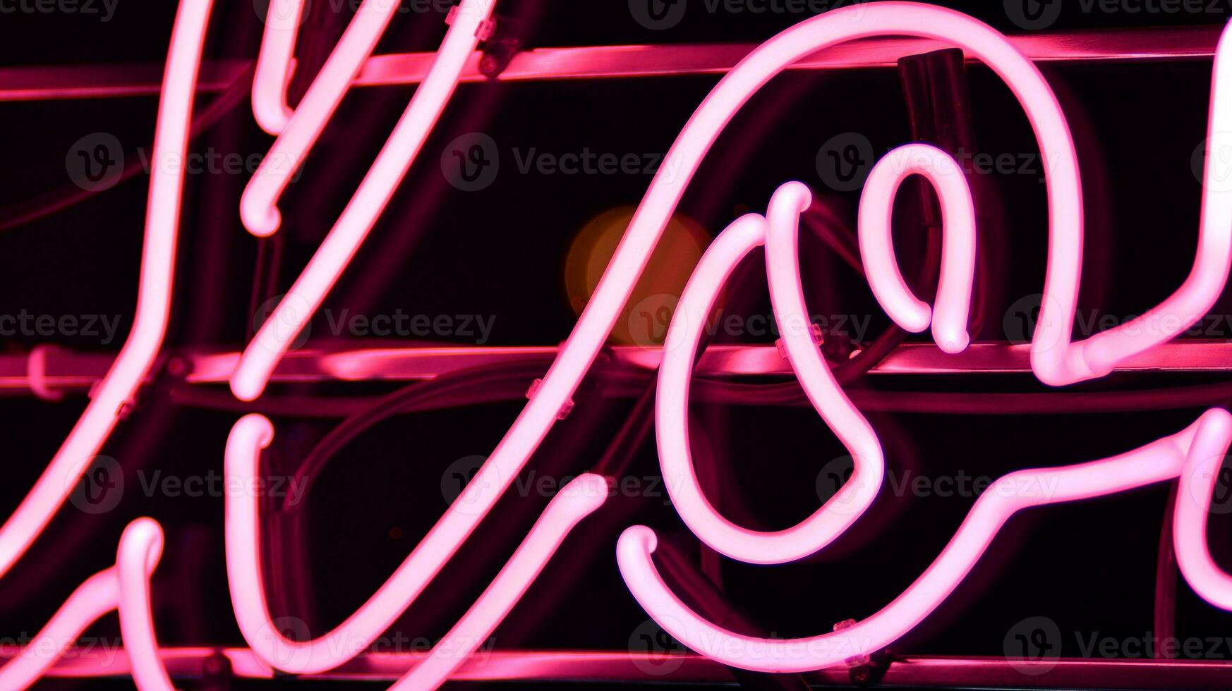 Glowing fragment of a neon sign, close-up, abstract background photo