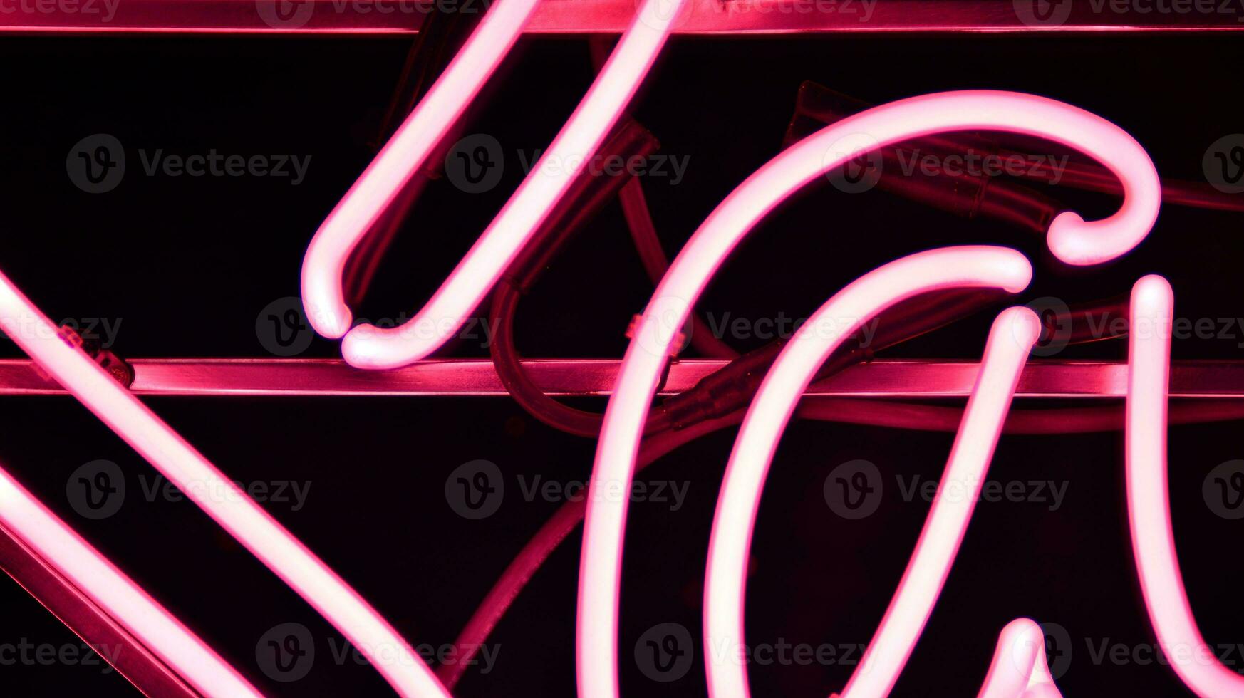 Glowing fragment of a neon sign, close-up, abstract background photo