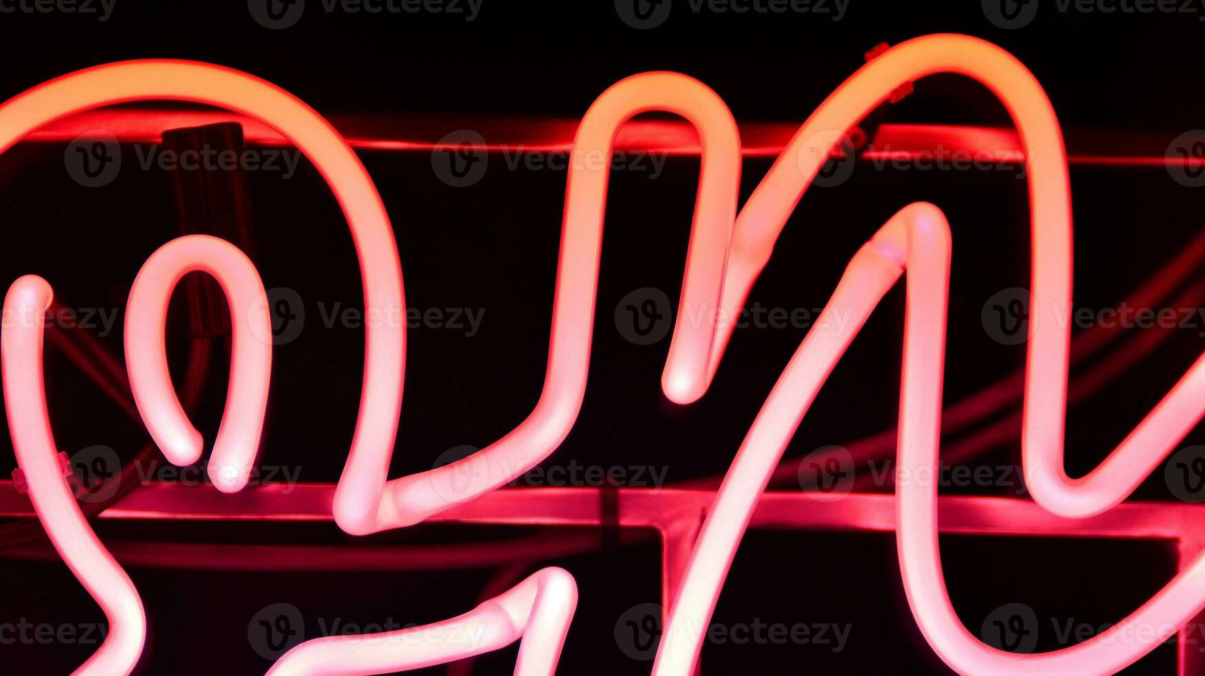 Glowing fragment of a neon sign, close-up, abstract background photo