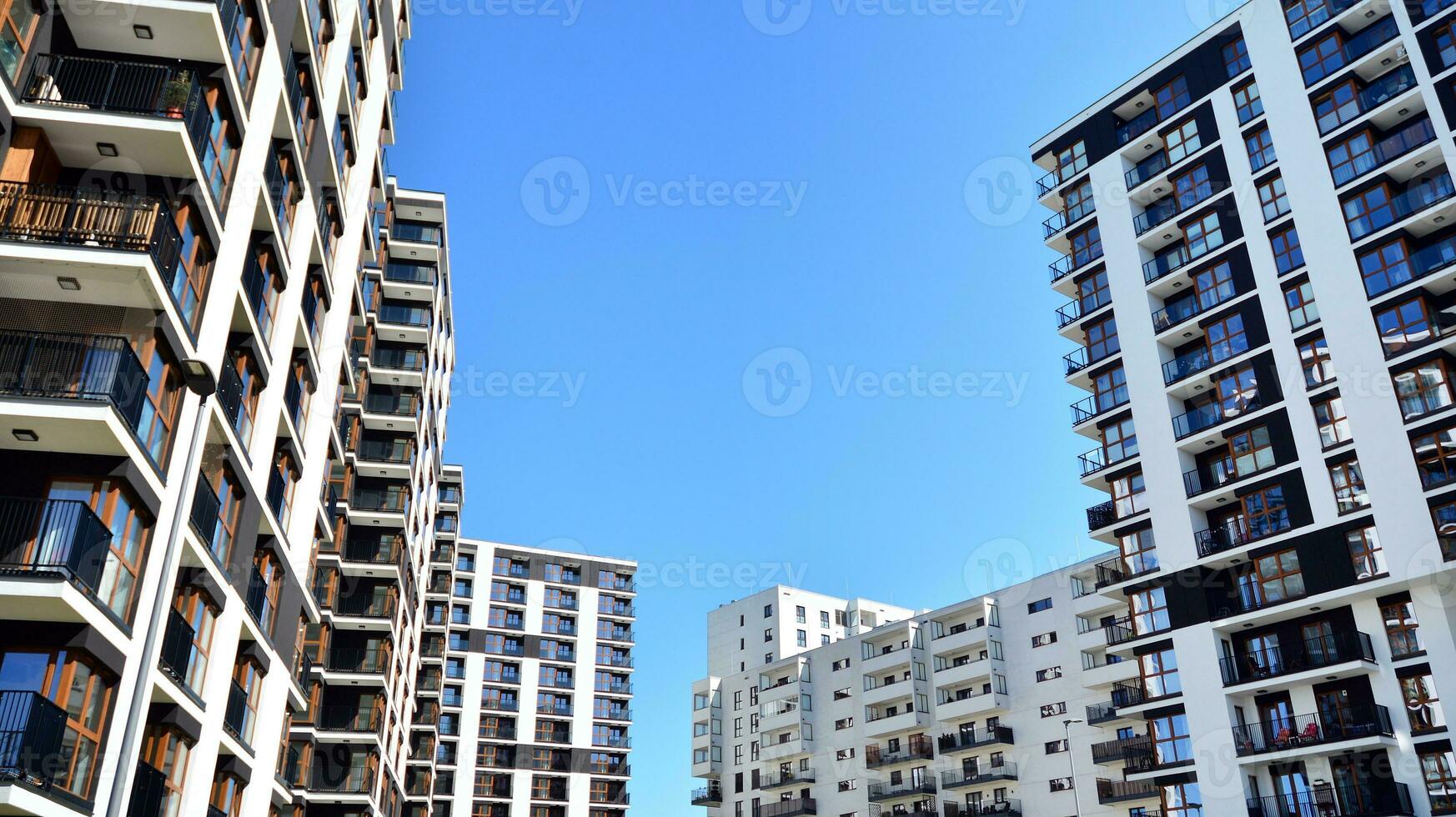 Exterior of a modern multi-story apartment building - facade, windows and balconies. photo