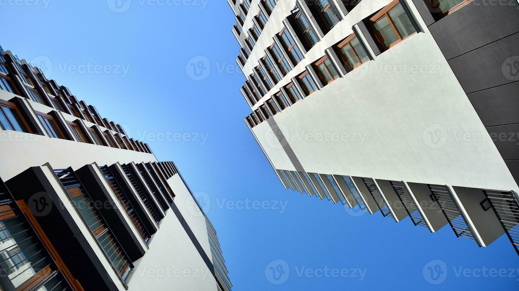 Exterior of a modern multi-story apartment building - facade, windows and balconies. photo