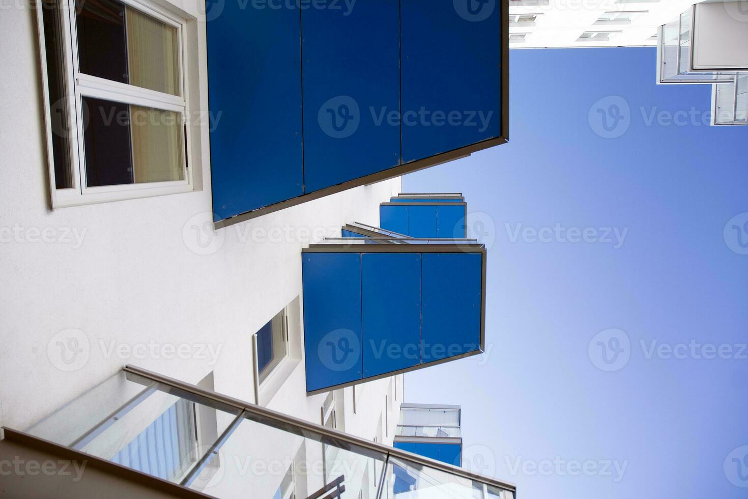 Exterior of a modern multi-story apartment building - facade, windows and balconies. photo