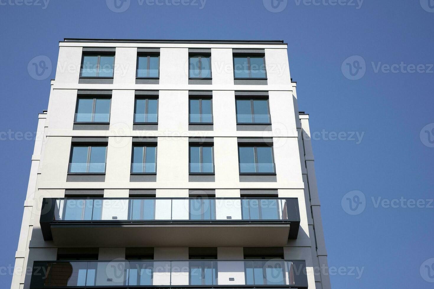 Condominium and apartment building with  symmetrical modern architecture in the city downtown. photo