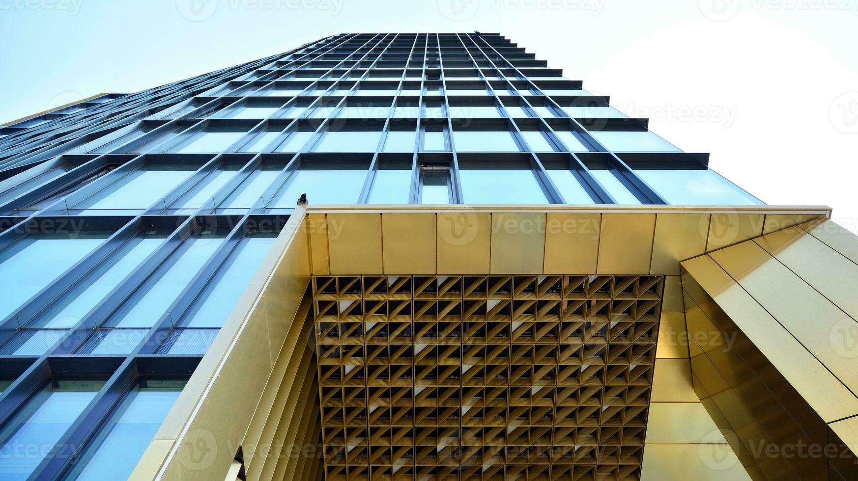 Combination of metal and glass wall material. Steel facade on columns. Abstract modern architecture. High-tech minimalist office building. Contemporary business architecture abstract fragment. photo