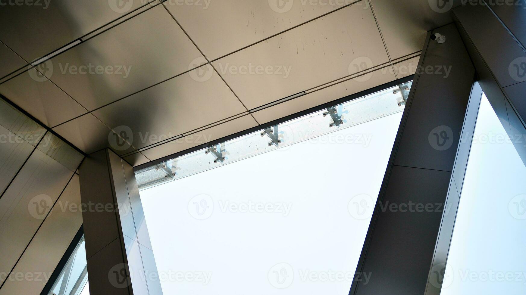 Combination of metal and glass wall material. Steel facade on columns. Abstract modern architecture. High-tech minimalist office building. Contemporary business architecture abstract fragment. photo