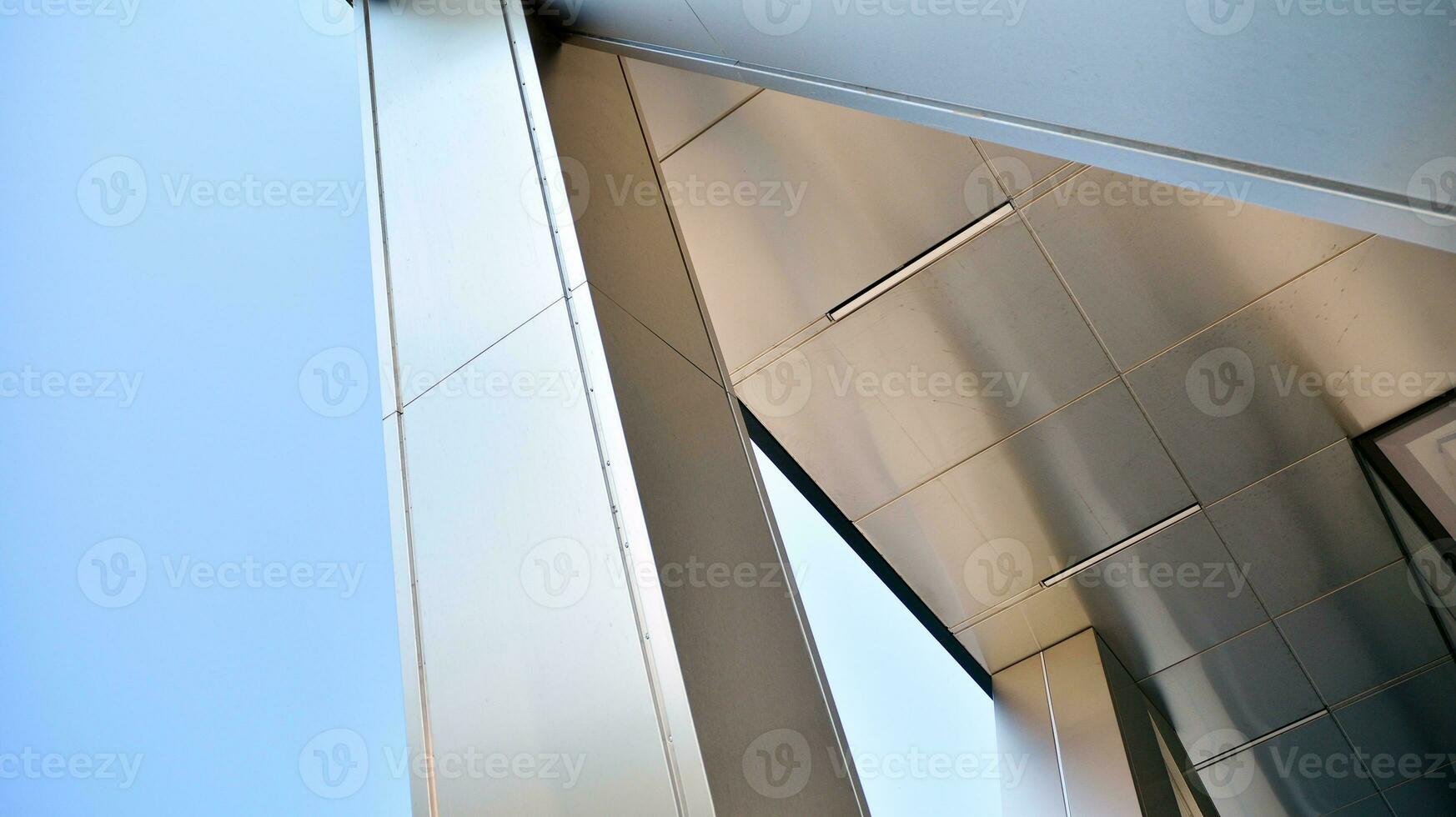 Combination of metal and glass wall material. Steel facade on columns. Abstract modern architecture. High-tech minimalist office building. Contemporary business architecture abstract fragment. photo