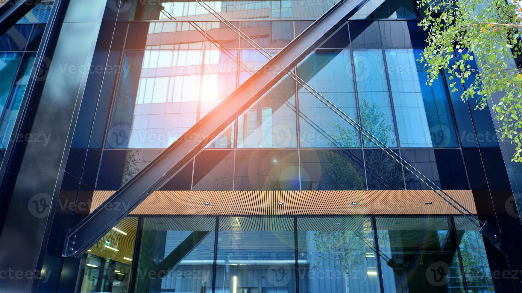 Combination of metal and glass wall material. Steel facade on columns. Abstract modern architecture. High-tech minimalist office building. Contemporary business architecture abstract fragment. photo