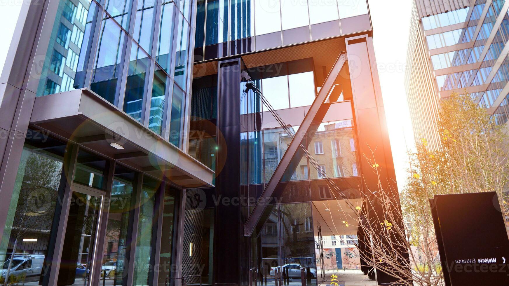 Combination of metal and glass wall material. Steel facade on columns. Abstract modern architecture. High-tech minimalist office building. Contemporary business architecture abstract fragment. photo