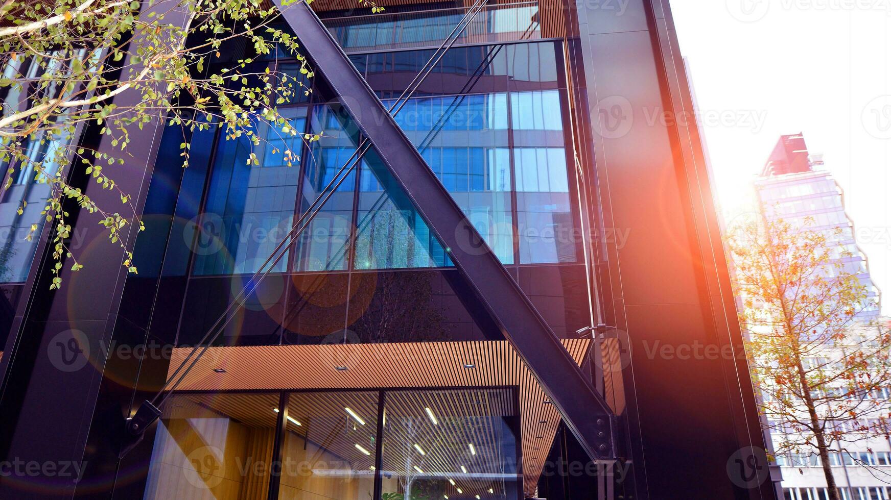 Combination of metal and glass wall material. Steel facade on columns. Abstract modern architecture. High-tech minimalist office building. Contemporary business architecture abstract fragment. photo