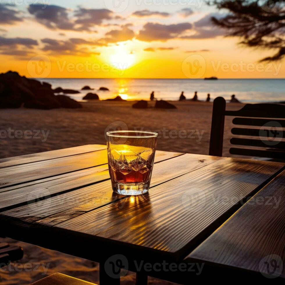 vaso de aperol rociar cóctel en de madera mesa con puesta de sol difuminar playa antecedentes ai generativo foto