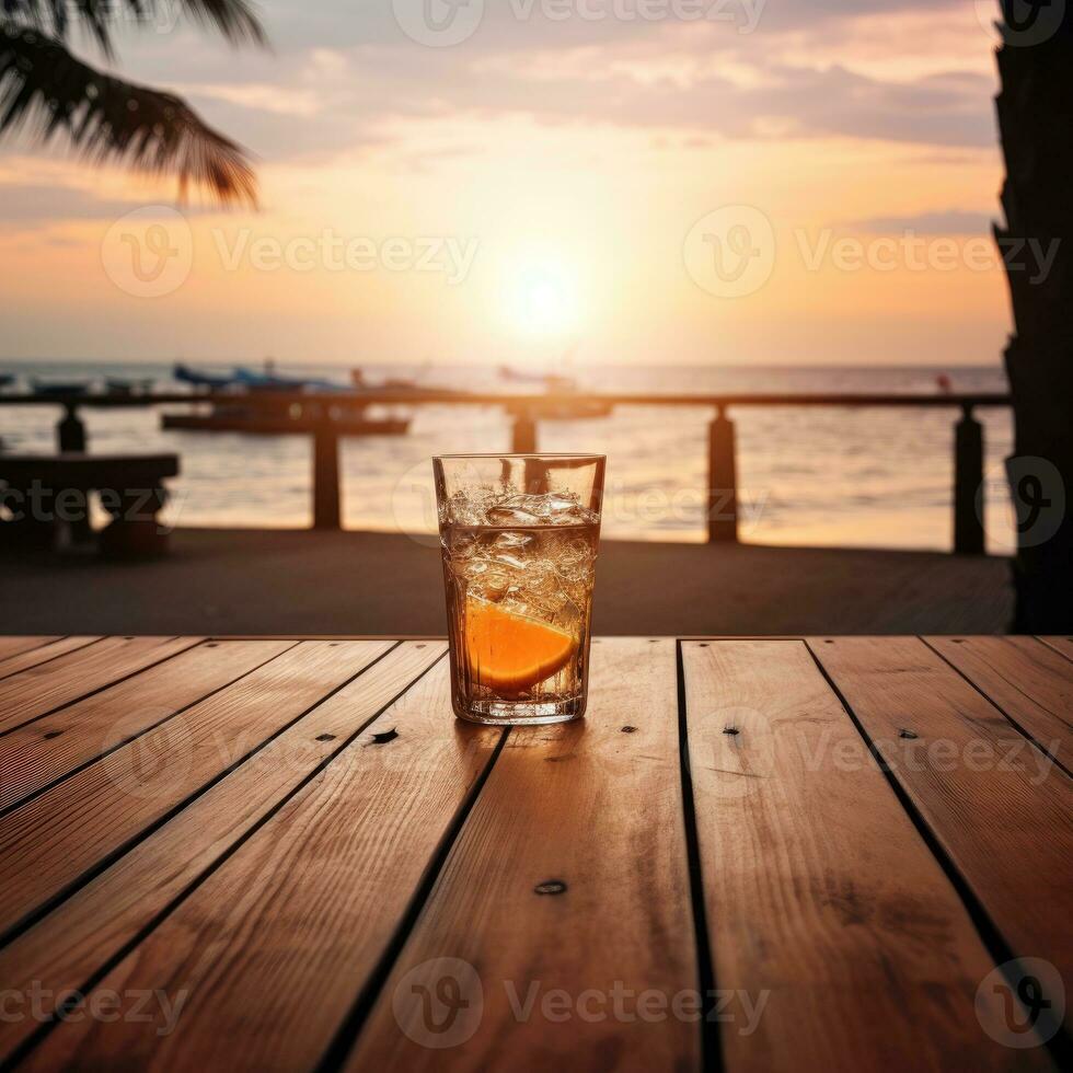 Glass of Aperol spritz cocktail on wooden table with sunset blur beach background ai generative photo