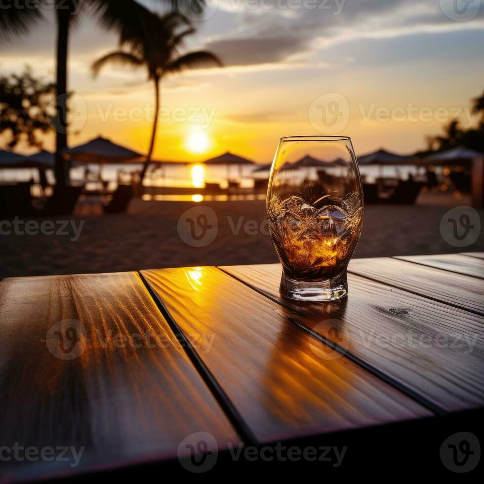 Glass of Aperol spritz cocktail on wooden table with sunset blur beach background ai generative photo