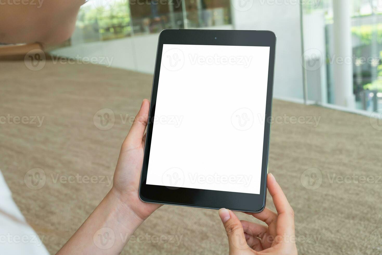 Hand holding digital tablet with blank screen for graphic display montage. photo