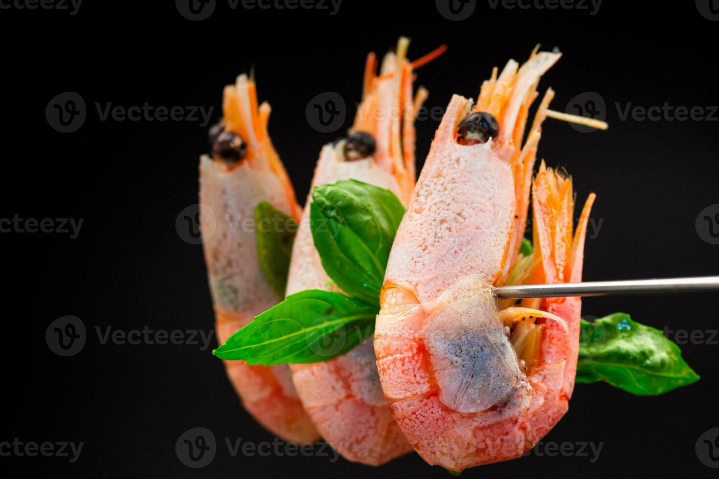 boiled shrimp with spices on black background photo