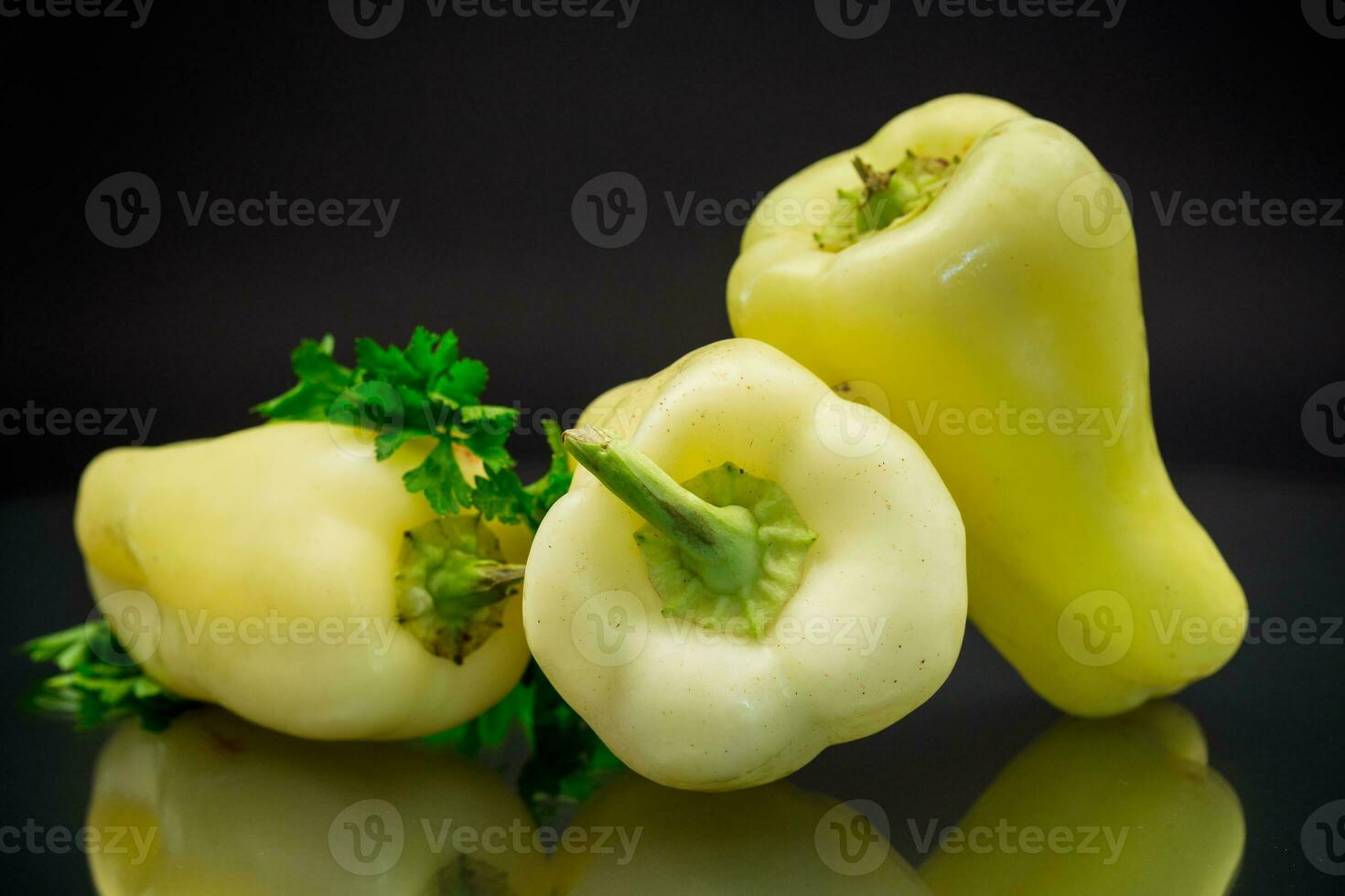 raw ripe green sweet pepper on black background. photo