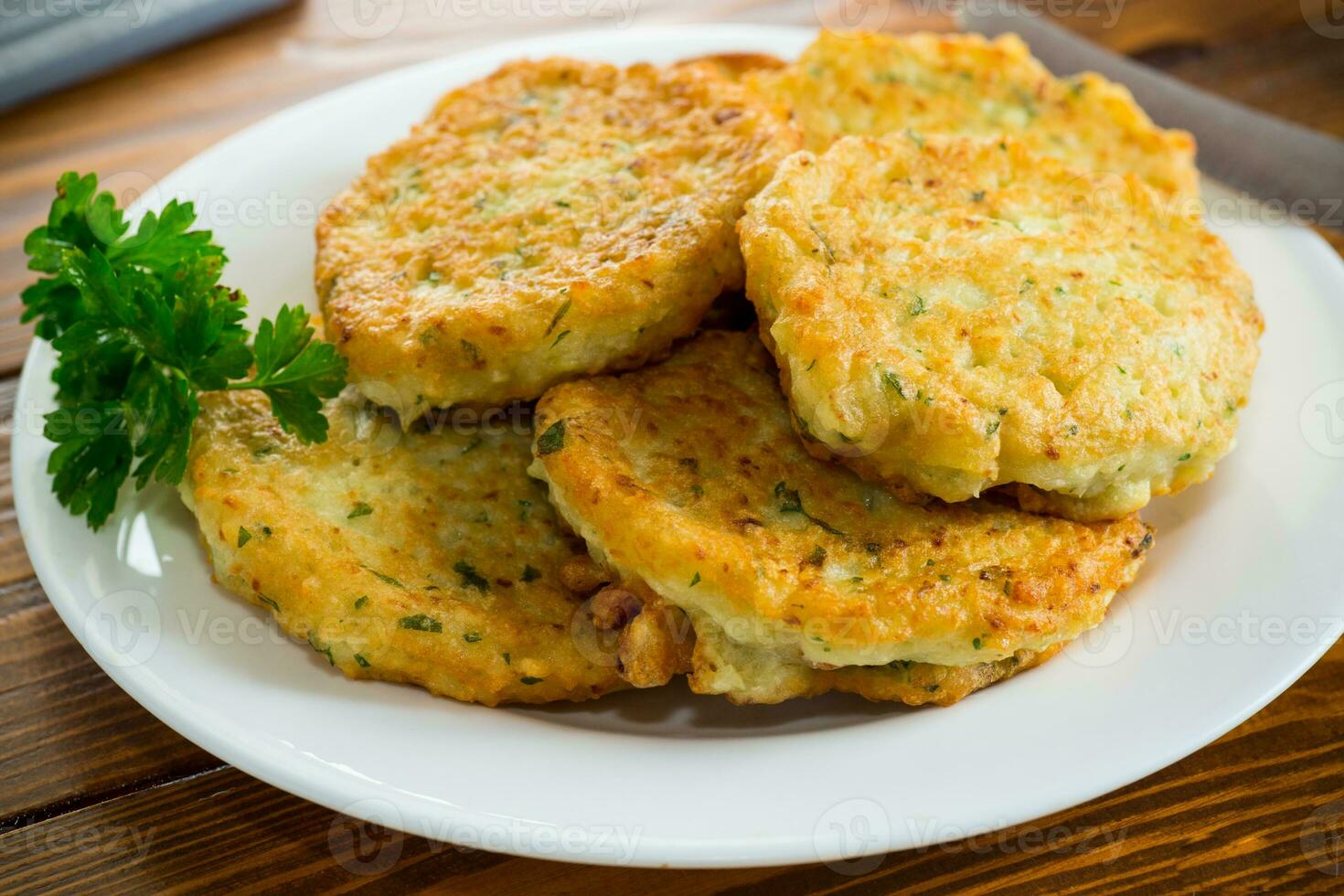cooked fried potato cutlets with herbs photo