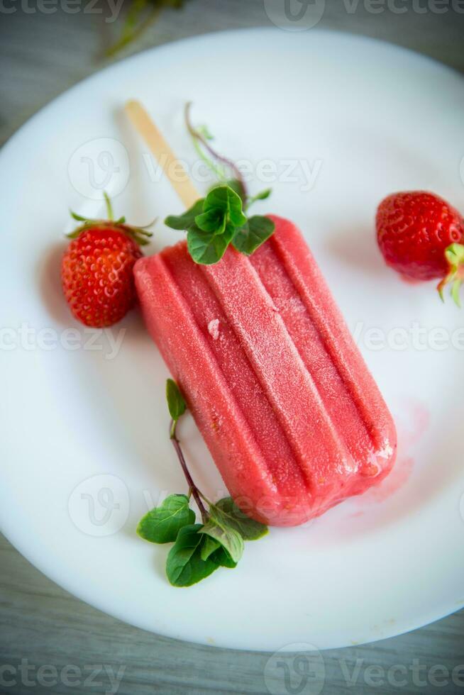 cooked homemade strawberry ice cream on a stick photo