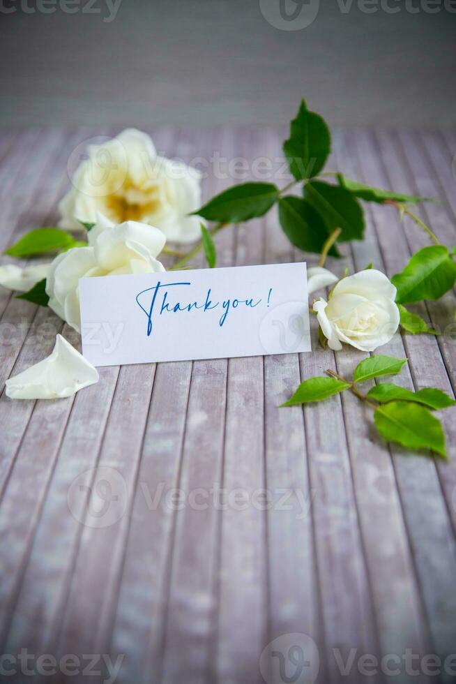 beautiful white summer roses, on a wooden table photo