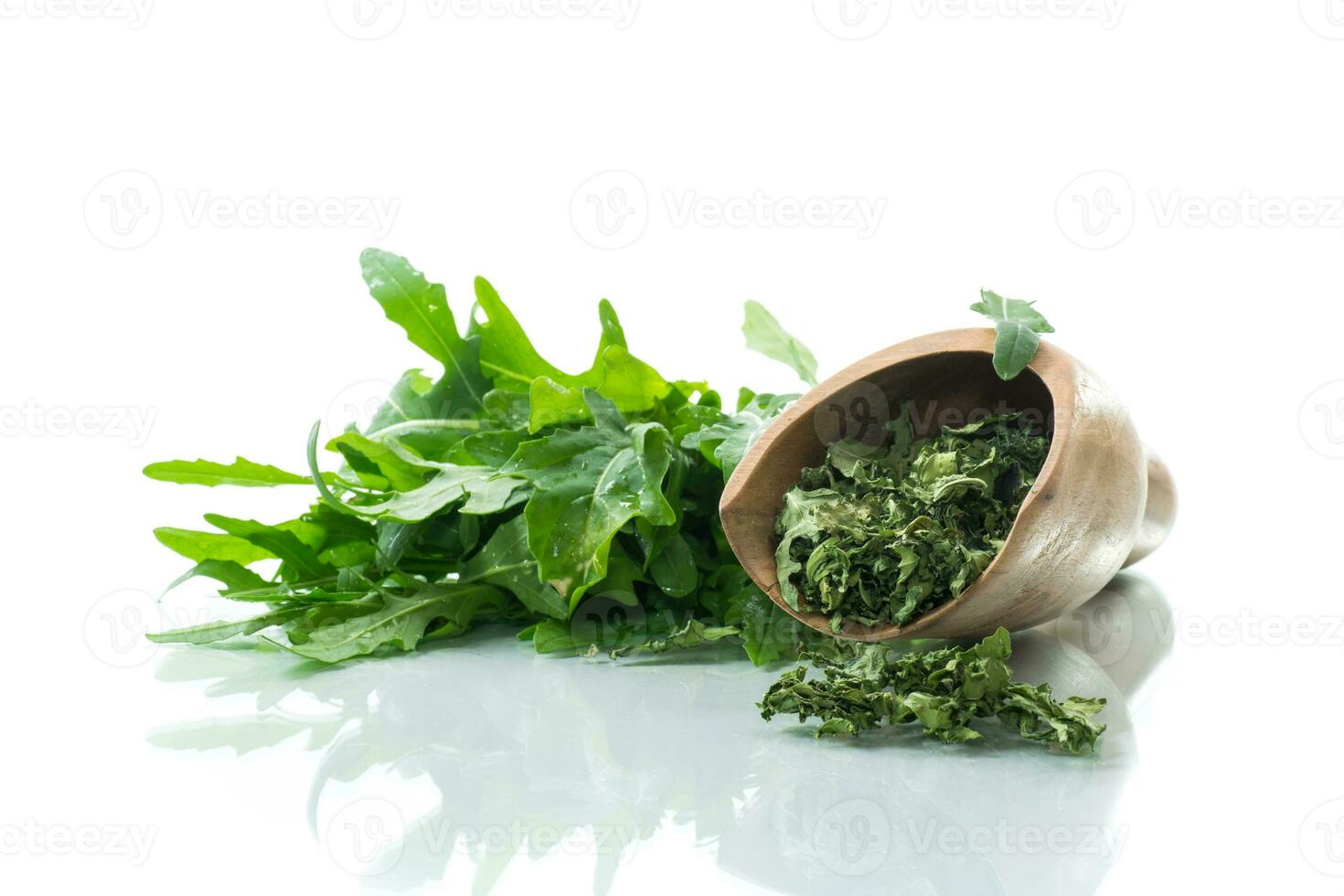 dried green organic arugula, seasoning, on white background. photo