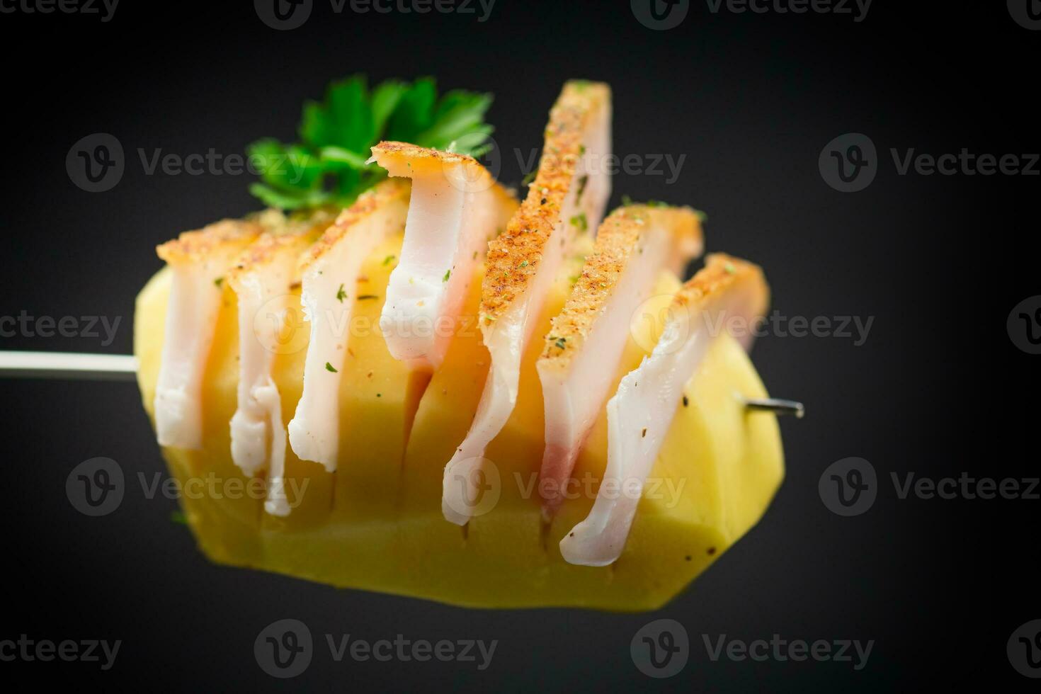 Raw potatoes prepared for baking, with lard on black background photo