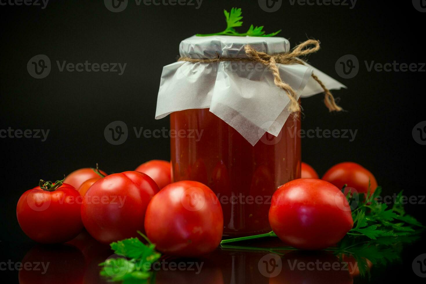 Cooked homemade tomato juice canned in a jar of natural tomatoes. photo