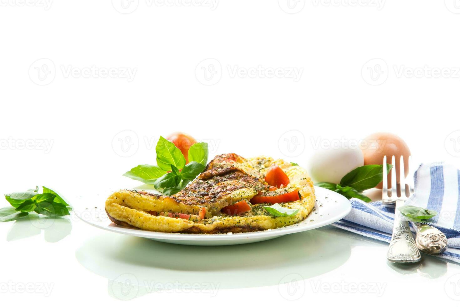 Stuffed omelette with tomatoes isolated on white background. photo