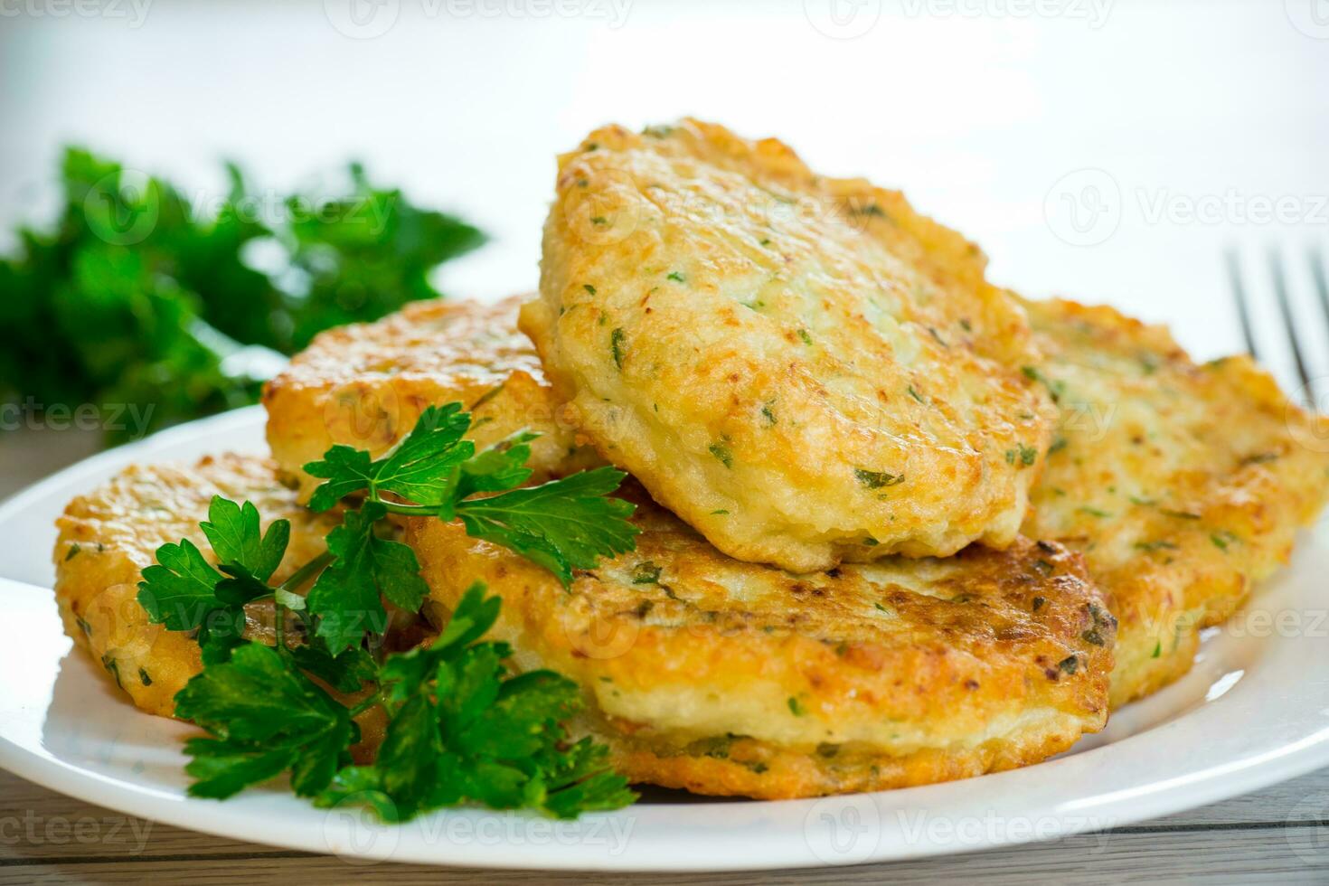cooked fried potato cutlets with herbs photo
