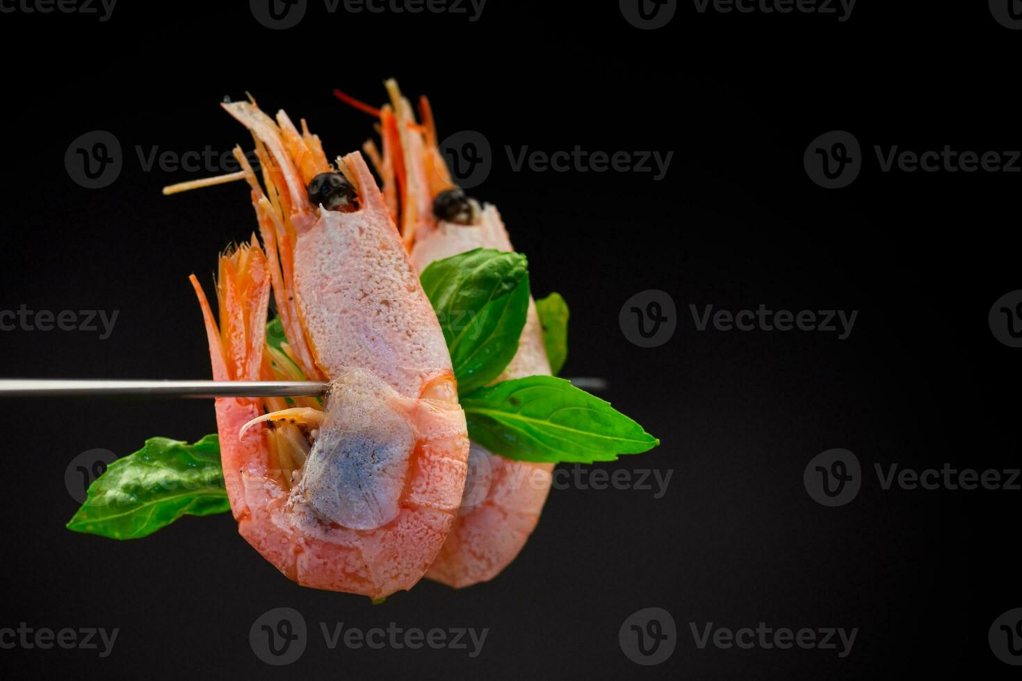 boiled shrimp with spices on black background photo