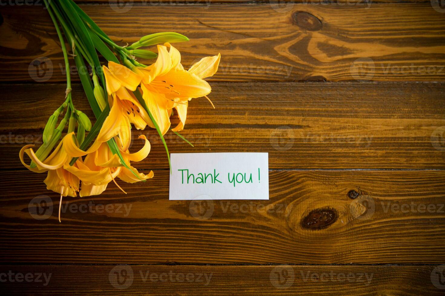 bouquet of beautiful yellow lilies on wooden table photo