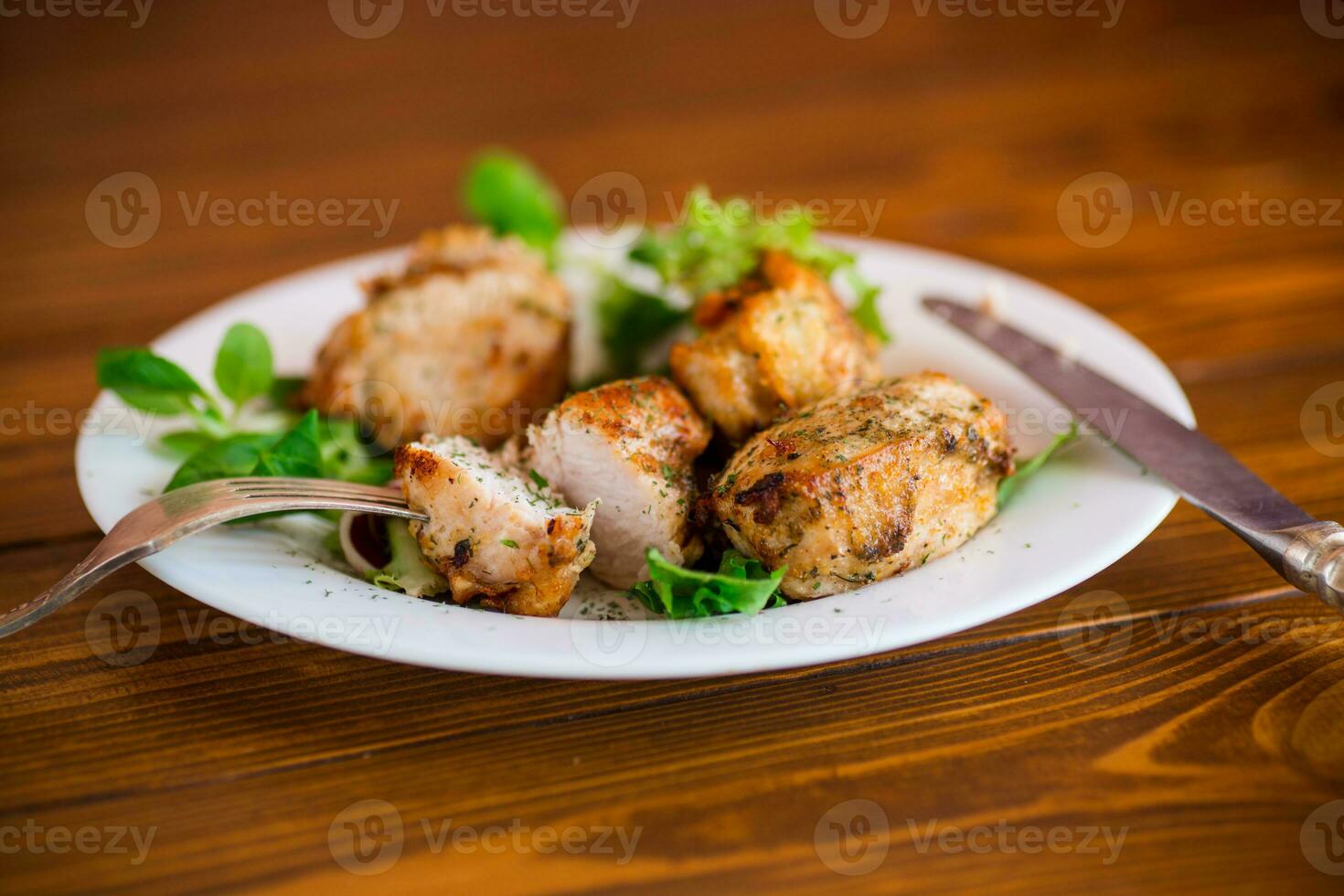 Fried pieces of chicken fillet breaded with spices and herbs in a plate . photo