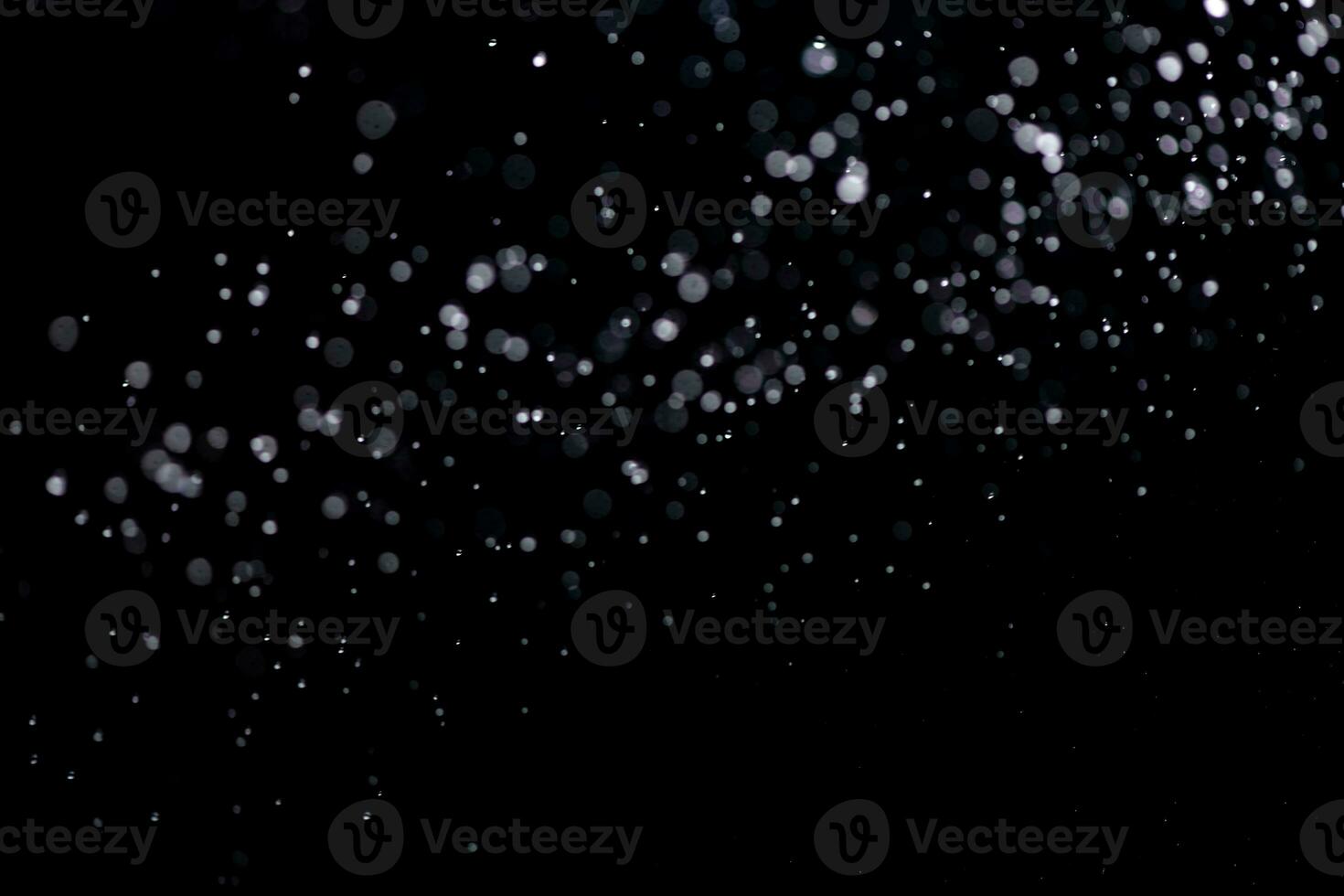 small drops of rain, snow on a black background. wind. Natural background photo