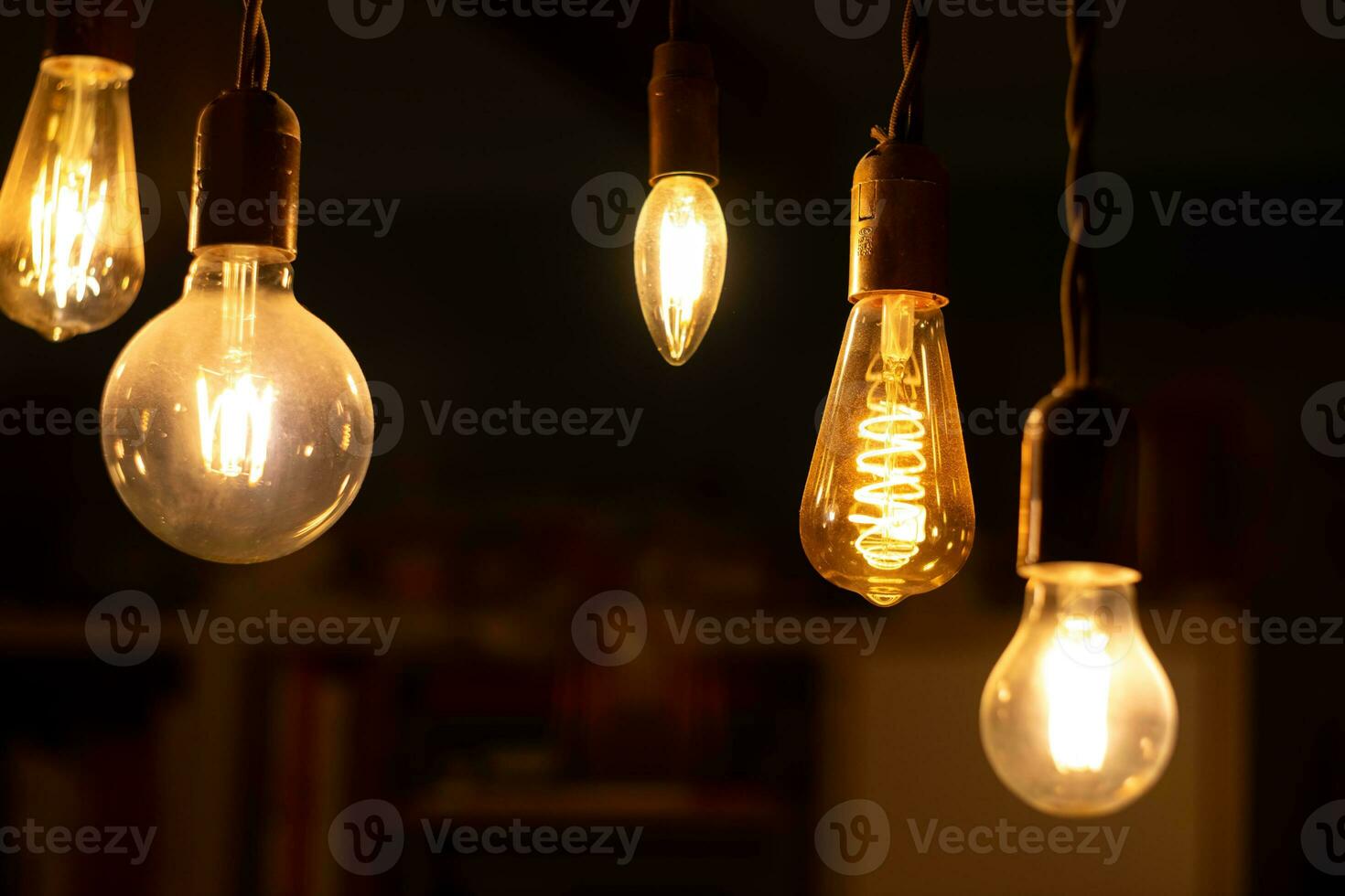 Retro light bulbs hanging on a dark background. Electricity, Vintage photo