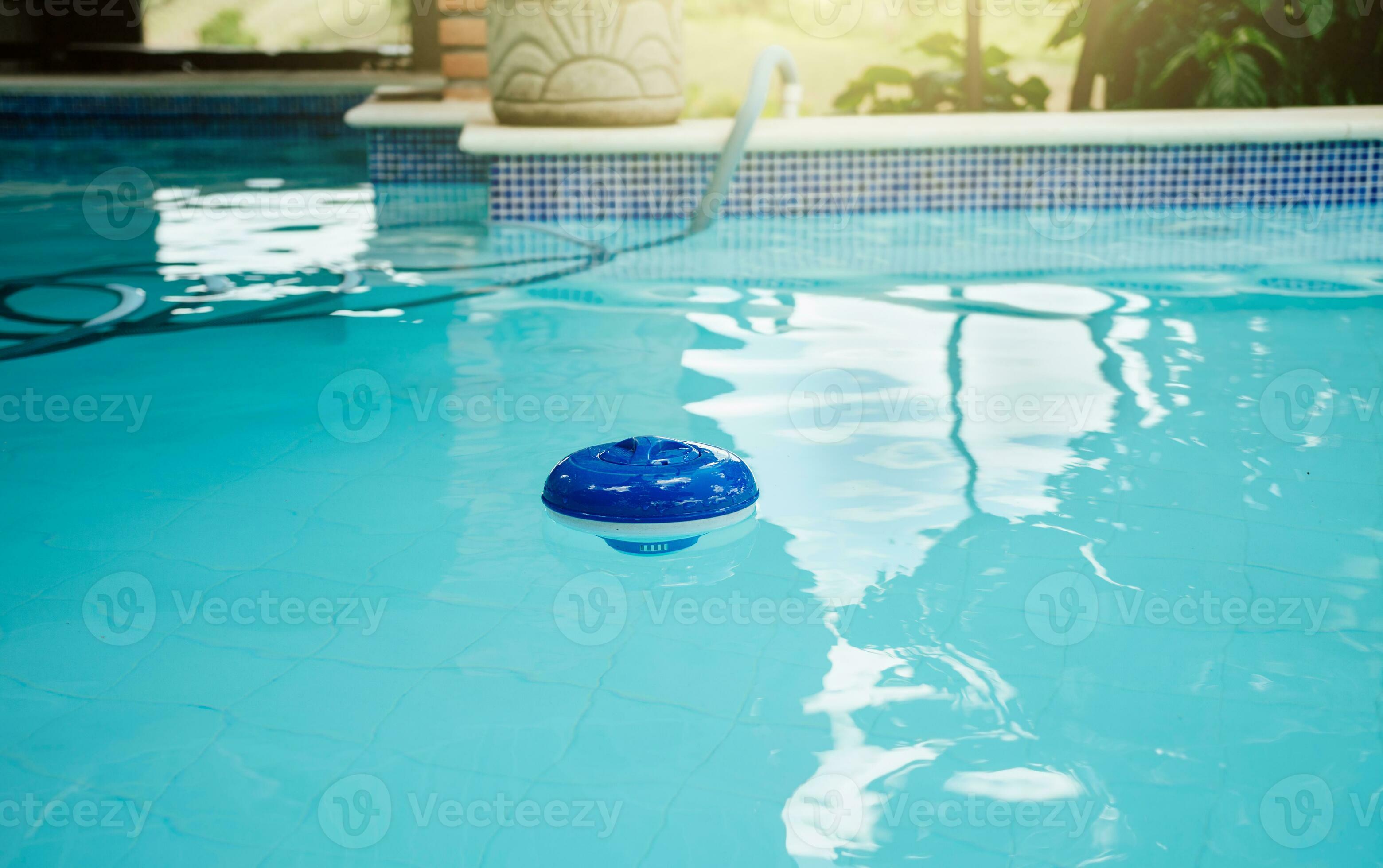 Chlorine dispenser in a beautiful swimming pool. A chlorine float in a